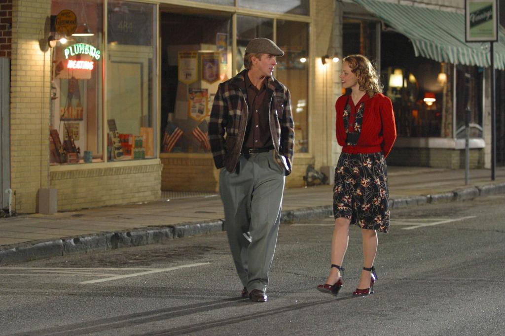 A young man and woman walk down the street