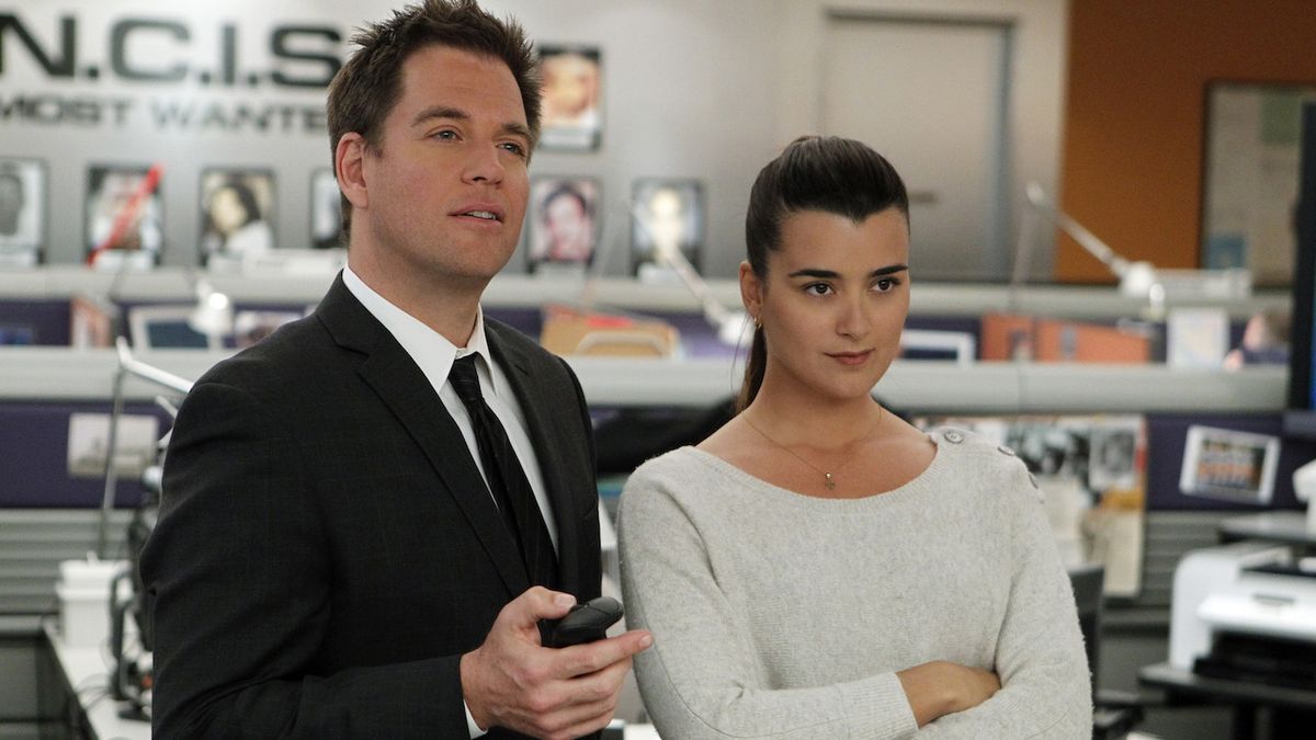 A male and a female NCIS agent standing next to each other