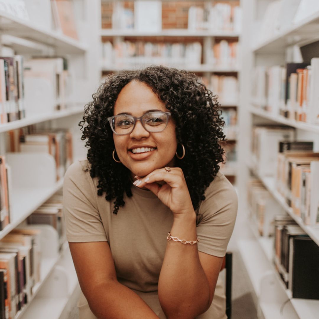 young woman wearing glasses in a library