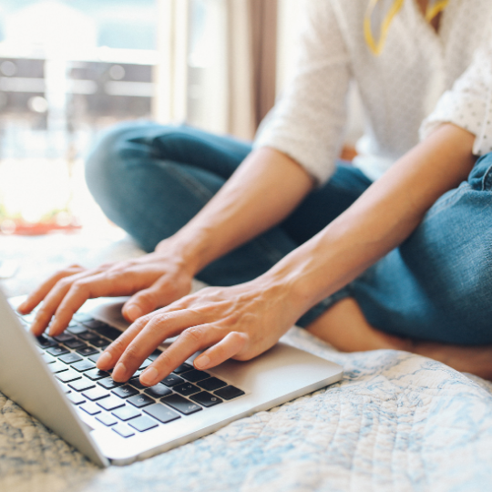 woman typing on laptop computer keyboard