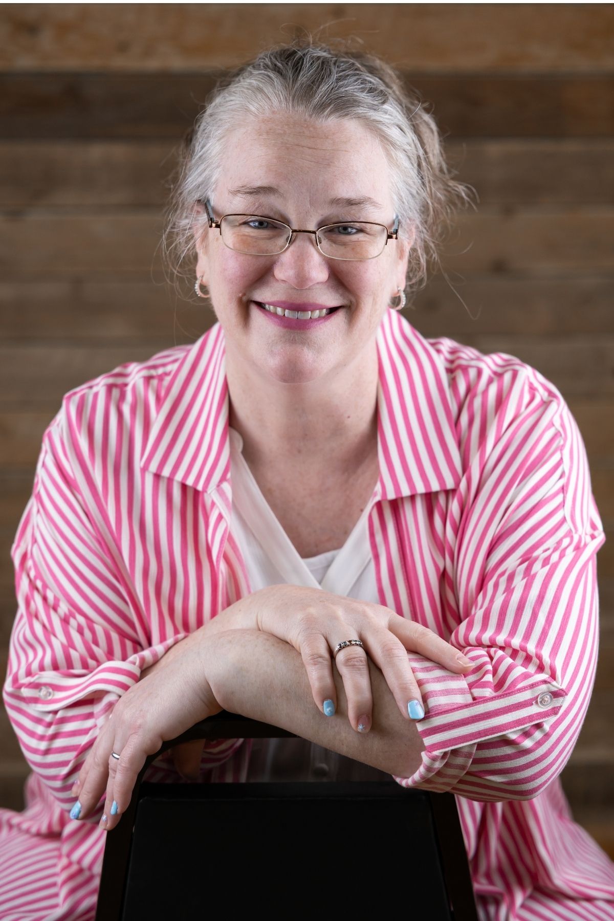 middle-aged woman with gray hair and glasses